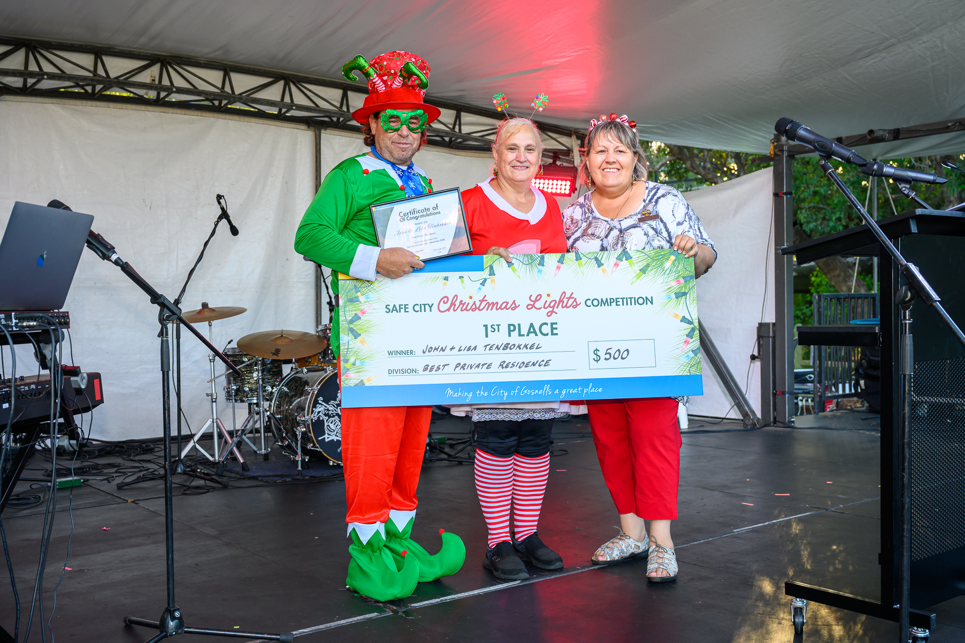 City of Gosnells Mayor Terresa Lynes (right) congratulates John and Lisa Tenbokkel on winning Best Decorated House in the Safe City Christmas Lights Competition.