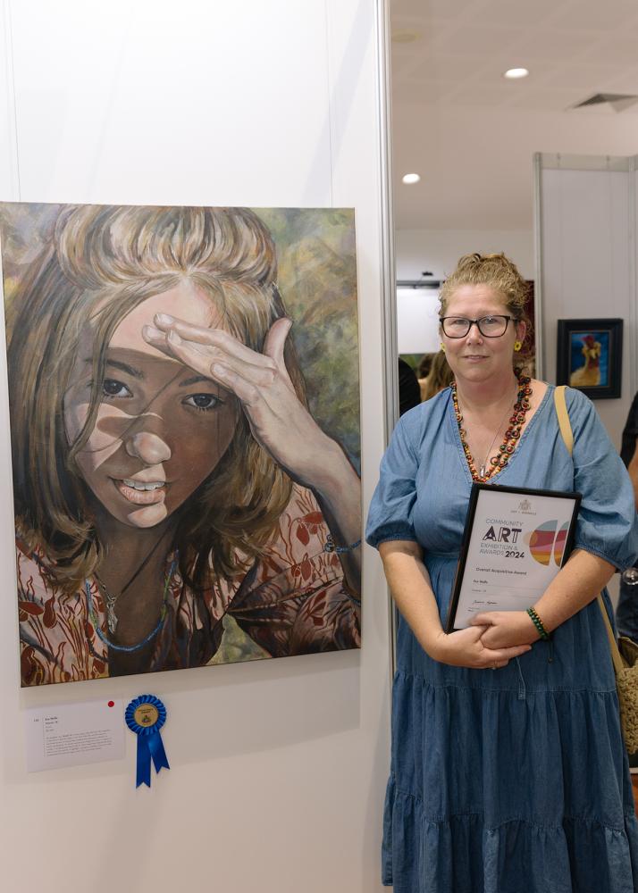Caption – City of Gosnells Community Art Exhibition and Awards Overall Acquisitive Prize  winner Eve Wolfe with her portrait of her daughter, titled Forever 18.
