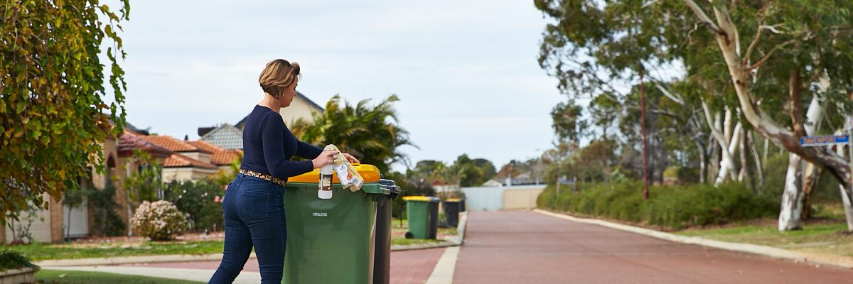 Resident places items in recycling bin