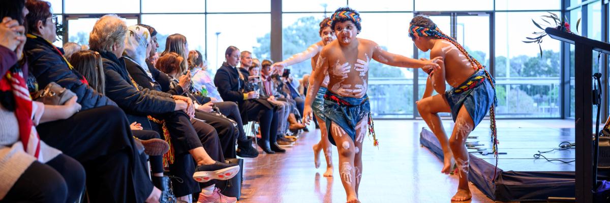 Young dancers perform in front of a crowd at NAIDOC Week celebrations