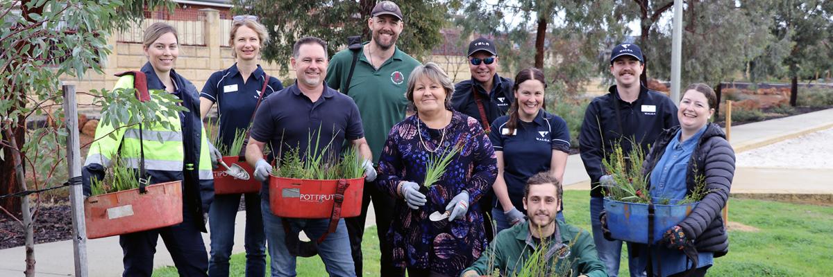City of Gosnells Mayor Terresa Lynes (centre), Councillor Aaron Adams, staff from the City WALGA and AGLG get ready to plant thousands of understorey plants at Atkinson Reserve in Canning Vale.