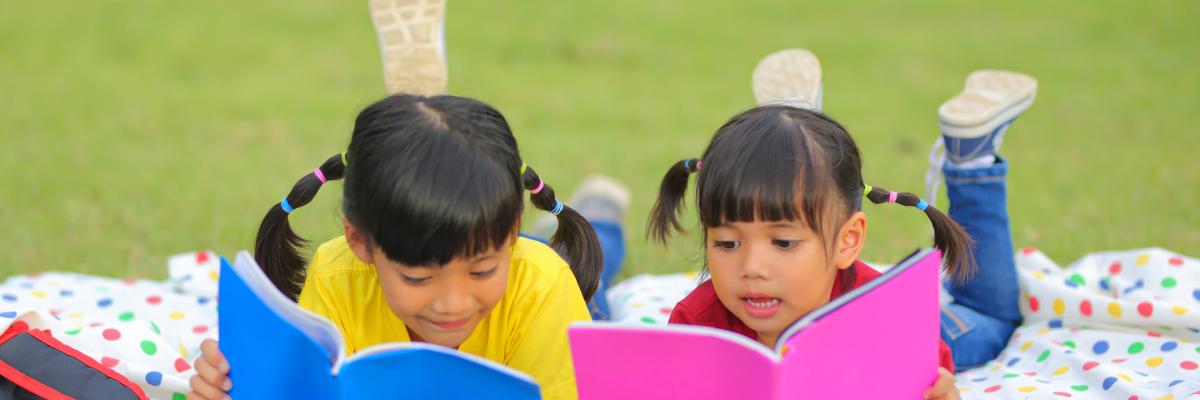 children reading outside