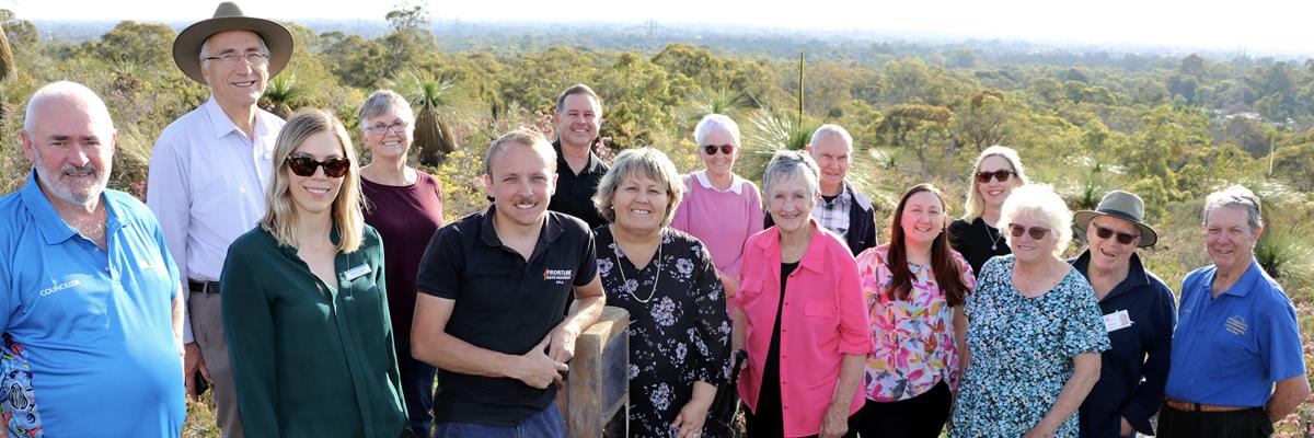 Caption – John Bowler’s grandson Kyle Scott Thompson and City of Gosnells Mayor Terresa Lynes (centre) celebrate the unveiling of a memorial plaque for John at Ellis Brook Valley. Also pictured are Councillor Kevin McDonald, Cr Peter Abetz, Environmental Officer Rachel Fitzgerald, Former Friends of Ellis Brook Valley member Jennie Greville, Cr Aaron Adams, Former Friends of Ellis Brook Valley members Rosemary and Rod Thompson, Armadale-Gosnells Landcare Group Chair Pat Hart, Cr Serena Williamson, Cr Caren B