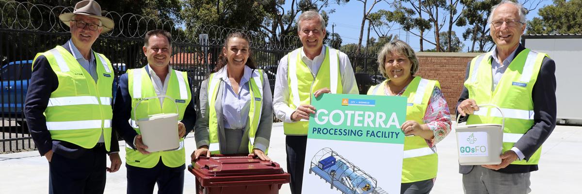 City of Gosnells Mayor Terresa Lynes and Environment Minister Reece Whitby hold a diagram of the planned Goterra processing facility, while Goterra CEO Olympia Yarger checks out one of the burgundy bins that will be provided to GOsFO participants, flanked by Councillors David Goode, Aaron Adams and Peter Abetz.
