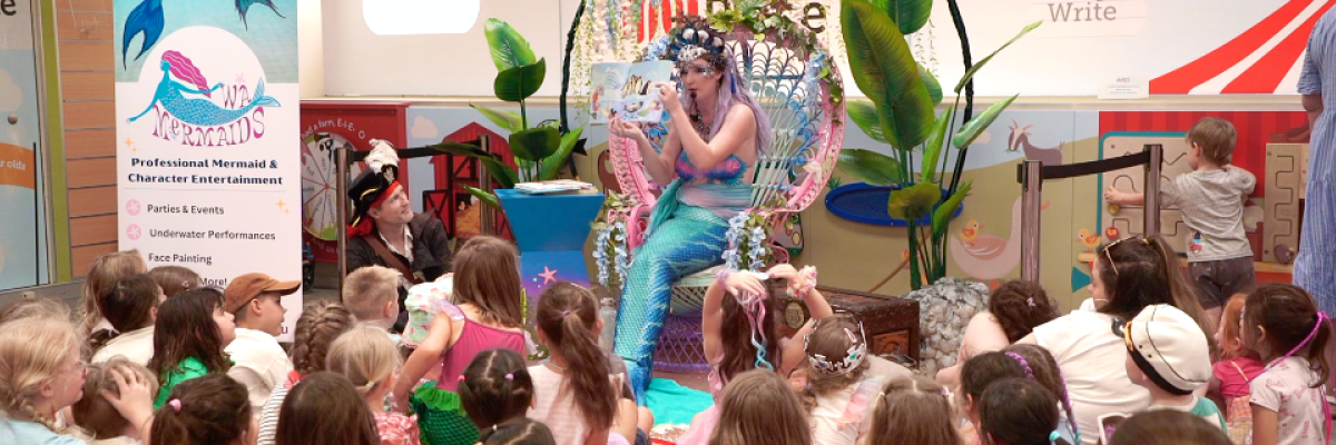 Mermaid Melody reading a story to children