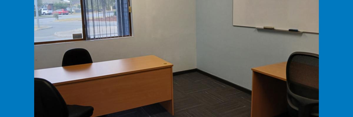 Small room with two desks and a whiteboard