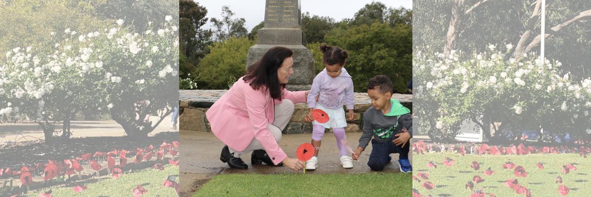 City of Gosnells Councillor and ex-servicewoman Kylie Dalton plants paper poppies with Shilo and Tobias at Anzac Gardens in Gosnells.