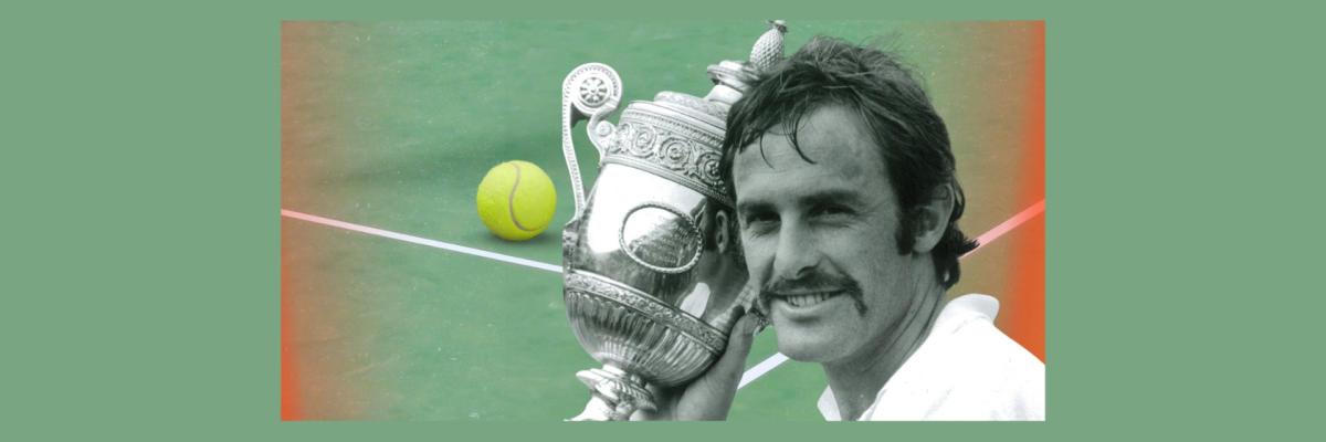 John Newcombe holds a trophy. Tennis court in background.
