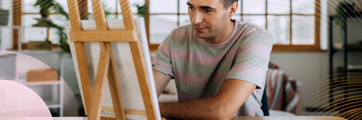 A person painting on a small canvas