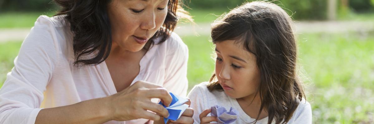 Japanese mother and daughter holding origami