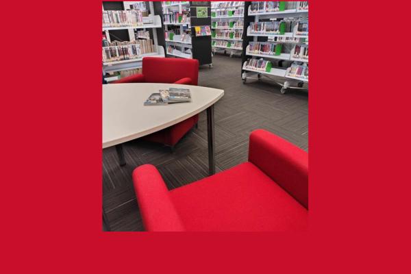 Red shelves and seating in Thornlie Library