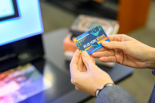 Library patron holding library card