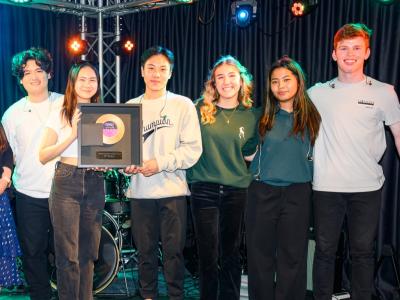State of Mind band Holding up their framed second place golden record