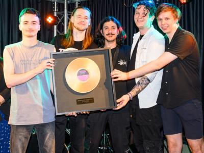 Viperchain Band Holding up their Golden Coloured First Place Record