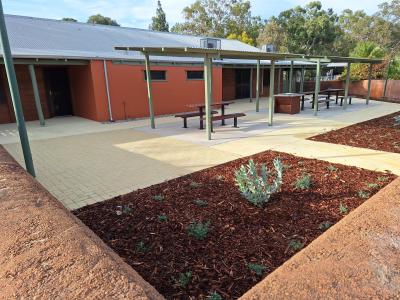 Courtyard showing newly planted garden beds, barbecue and undercover picnic seating at the rear of the centre