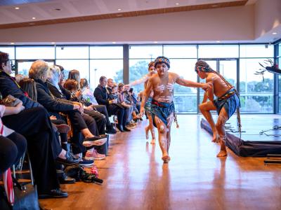 Young dancers perform in front of a crowd at NAIDOC Week celebrations