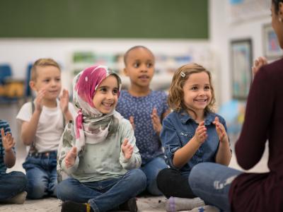 Group of children listens to storyteller.