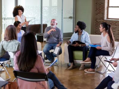 Group of people in a workshop sitting on chairs