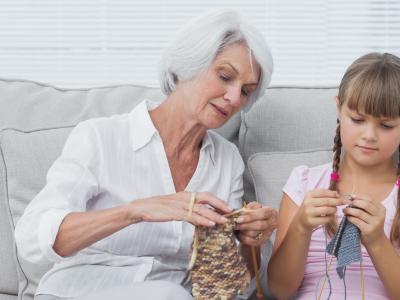 Grandmother teaching grandaughter knitting