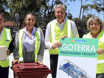 City of Gosnells Mayor Terresa Lynes and Environment Minister Reece Whitby hold a diagram of the planned Goterra processing facility, while Goterra CEO Olympia Yarger checks out one of the burgundy bins that will be provided to GOsFO participants, flanked by Councillors David Goode, Aaron Adams and Peter Abetz.