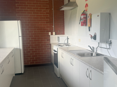 Kitchen with benches, fridge, urn and oven