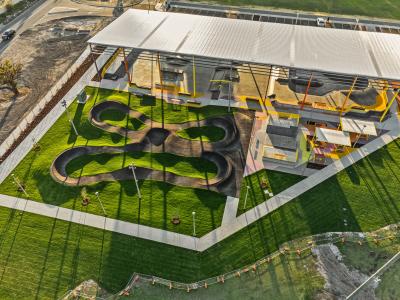 Aerial view of YES showing large roof and winding pump track in grass