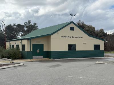 External of Southern River Hall showing green roof, cream walls and a portion of the car park