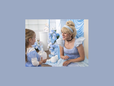 Small child meets character actor dressed as Cinderella.