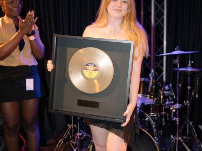 Ava Sharp holding her 1st Place Golden Record