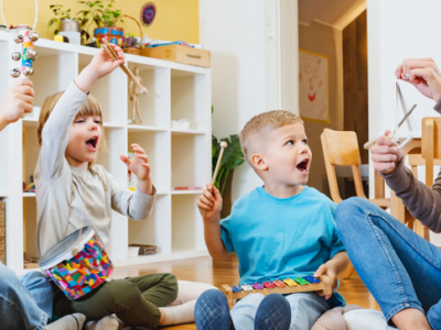 Children playing musical instruments on the floor.