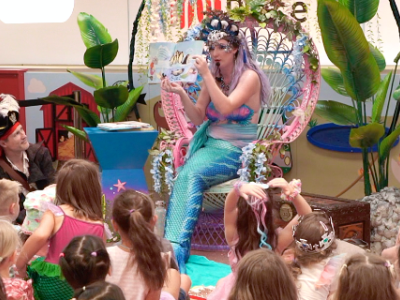 Mermaid Melody reading a story to children