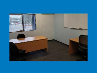 Small room with two desks and a whiteboard