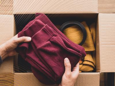 image of a person sorting items into a cardboard box