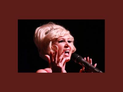 Dusty Springfield impersonator sings into a microphone