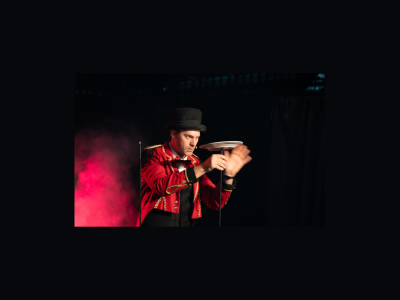 Circus performer focuses intensely on a spinning plate