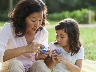 Japanese mother and daughter holding origami